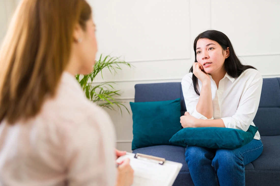 A woman participates in therapy at an addiction treatment center.